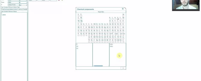 Screenshot of a software interface displaying a periodic table within a dialog box. The interface includes menu options, buttons, and a small profile image on the top right.