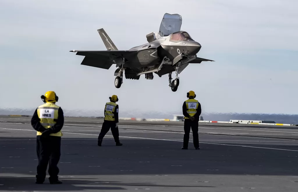 A Royal Air Force RAF F35B Lightning II performing a vertical landing on a Royal Navy carrier.