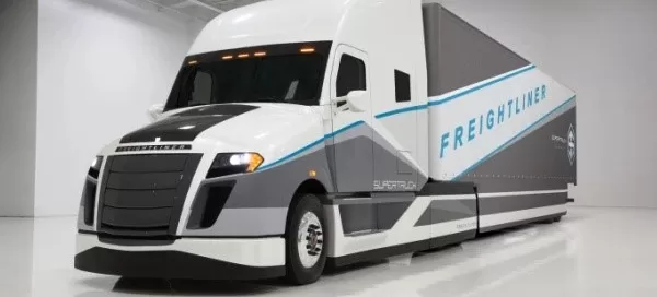 Futuristic Freightliner truck in a white studio, featuring streamlined design and "SuperTruck" branding.