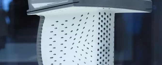 Cross-section of a turbine blade displaying internal cooling passages and perforations.