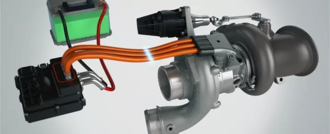 A turbocharger connected to various components with orange wires.