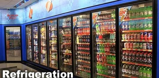 Refrigerated display case filled with various bottled and canned beverages in a store.