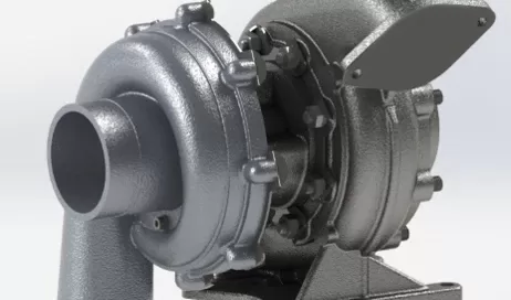 A metallic industrial pump with a cylindrical outlet and several bolts, mounted on a base.